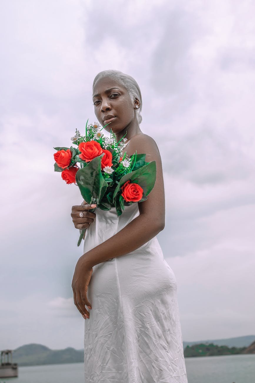 african woman holding bouquet of roses