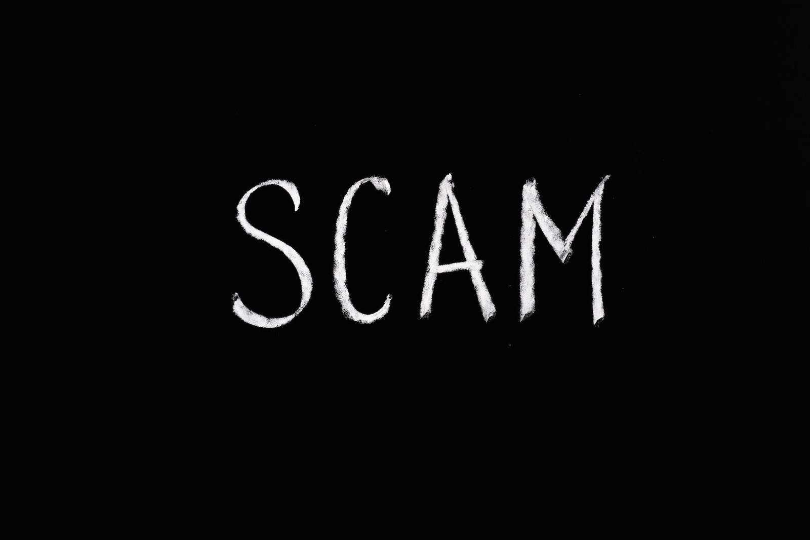 scam lettering text on black background