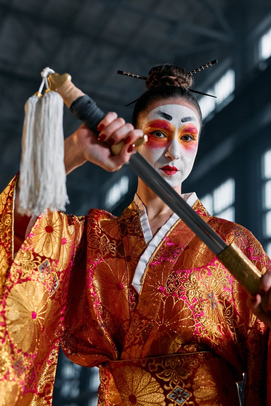 a woman in a kimono holding a sword